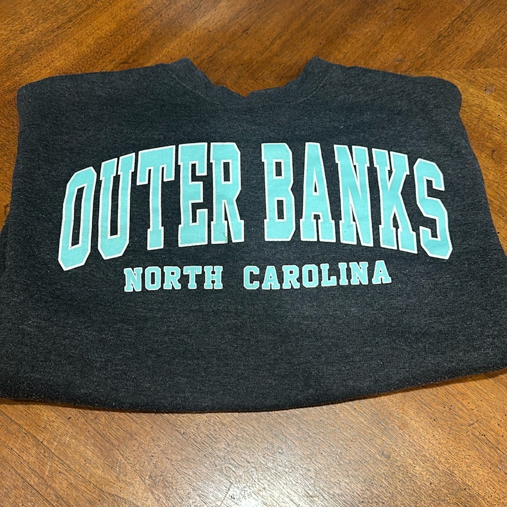 Outerbanks dark grey crewneck with teal lettering